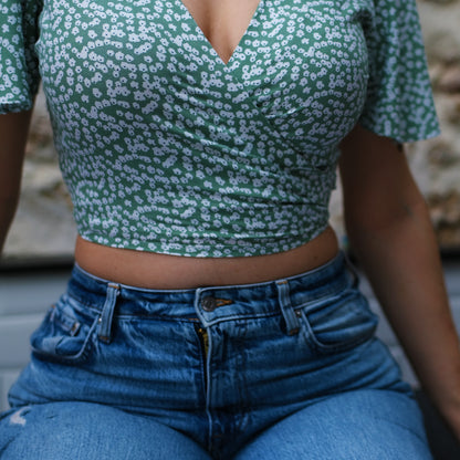 Femme assise portant un top croisé par le devant